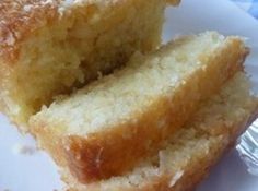 two pieces of bread sitting on top of a white plate next to another piece of cake