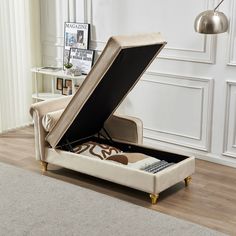 an open suitcase sitting on top of a bed in a room with wooden floors and white walls