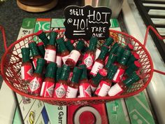 a basket full of hot sauces sitting on top of a counter next to a sign that says sell hot