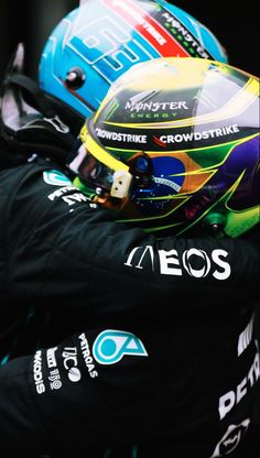 the helmet of a racing driver sits on top of his jacket