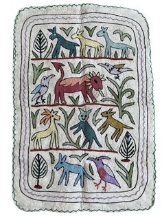 an embroidered square with animals and plants on it's sides, in white background