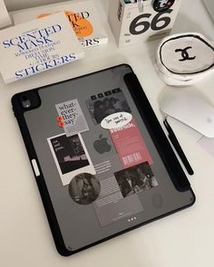 an ipad is sitting on a desk next to some books and other things that are in front of it