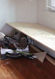 a pair of skis sitting on top of a wooden floor next to a window