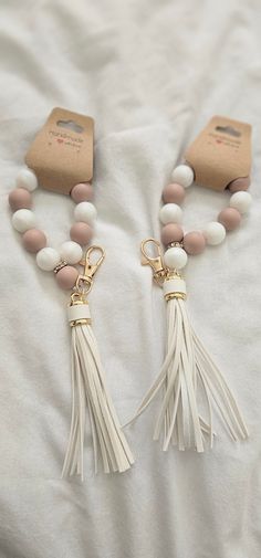 Elegant, hand made mini tasbih/prayer bead keychain. Featuring 11 13mm sized rubber beads for remembrance, this keychain serves as a stylish accessory and a practical tool for spiritual reflection. with a stylish white leather tassle. Easily attach it to your bag or keys for convenient access, making it an ideal companion for those seeking moments of tranquility and devotion. Bead Keyring, Spiritual Reflection, Rubber Bead, Bead Keychain, Beaded Keychains, Prayer Beads, Stylish Accessories, Beautiful Hand, You Bag