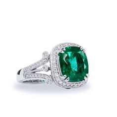 Turn the world green with envy wearing this gorgeous 4.09 carat GIA certified cushion cut Zambian Emerald ring, decorated with 0.71 carats in total weight of diamonds (G/H - VS) all displayed on an 18 karat white gold split shank band. SKU: 15475 Luxury Emerald Ring With Cushion Cut Center Stone, Luxury Cushion Cut Emerald Ring With Center Stone, Green Platinum Jewelry With Pave Setting, Luxury Cushion Cut Emerald Ring With Diamond, Luxury Green Asscher Cut Diamond Ring, Formal Cushion Cut Emerald Ring In White Gold, Luxury Green Cushion Cut Emerald Ring, Luxury Cushion Cut Emerald Ring With Prong Setting, Gia Certified Cushion Cut Diamond Emerald Ring