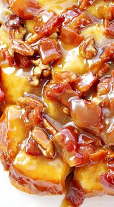 a close up of food on a plate with sauce and nuts in the middle,