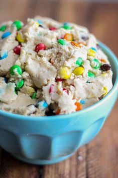 a blue bowl filled with ice cream covered in sprinkles