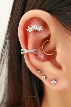 a woman with three piercings on her ear