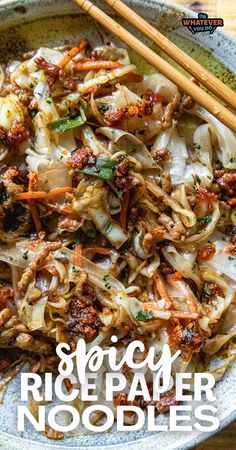 a bowl filled with noodles and vegetables next to chopsticks