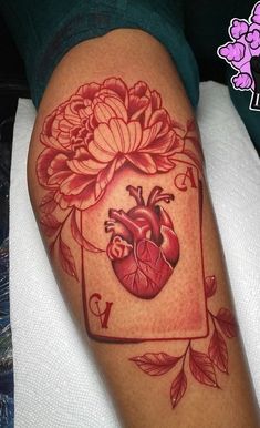 a heart and flowers tattoo on the leg