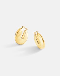 A clean sleek medium size hoop earrings made in 18k gold plated over sterling silver. The earrings have a modern twist on a classic hoop earring design with a rectangular gap in between the hoop stamp of the earrings. Our hand polished finish on the earrings creates a perfect flawless shine that exuberates luxury. Utilizing our exclusive Italian electroforming production technologies allows these earrings to be in a comfortable weight for long hours of wearing. Available in 18K yellow gold or white gold color. Bamboo Hoop Earrings, Chunky Hoop Earrings, Earring Sale, Perfect Gift For Her, Ear Jewelry, Huggies Earrings, Designer Earrings, Shop Earrings, Post Earrings