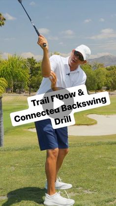 a man holding a golf club on top of a green grass covered field with the words trail bow & connected backswing drill