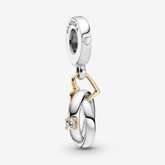 Carry a symbol of forever love with the Two-tone Wedding Rings Dangle Charm. This silver charm features a 14k gold heart link with two entwined rings, one sterling silver solitaire with a sparkling stone set in a 14k gold setting and one sterling silver band. Both feature the engraved messages 'You and I' and 'Forever and always' inside. The bail includes the iconic Pandora logo and two raised hearts. There's no better way to symbolise your love and commitment. - Pandora Two-tone Wedding Rings Dangle Charm - Sterling silver and 14k Gold / Cubic Zirconia / Clear Pandora Accessories, Unode50 Jewelry, Pandora Logo, Christmas Necklace, Dangle Charms, Forever Love, Sterling Silver Bands, Gold Set, Gold Heart