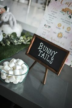 there is a sign that says bunny tails next to marshmallows in a bowl