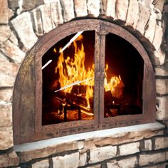 a fire burning inside of a brick oven