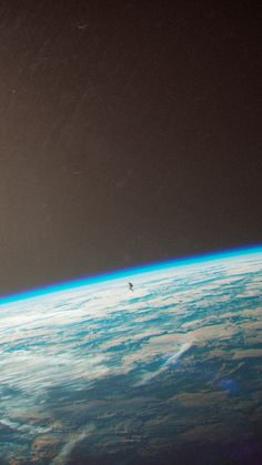 an airplane flying over the earth at night