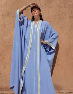 Indulge in the elegance of Moroccan fashion with our 2 Pieces Crepe Co-ord in the enchanting Blue hue. This coordinated set seamlessly combines tradition and modernity, creating a statement ensemble that exudes sophistication.   Product Details:      Open Oversized Abaya with Sfeefa and Pearls : The open abaya in this set is crafted from luxurious crepe fabric and features intricate handmade sfeefa and pearls details, adding opulence and Moroccan charm to your look.     Sleeveless Kaftan Underdr Open Abaya, Moroccan Fashion, Moroccan Dress, Crepe Fabric, Co Ord, Blue Hues, Blue Color, V Neck, Fabric