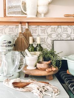 the kitchen counter is cluttered with spices and other things to make it easier for cooking