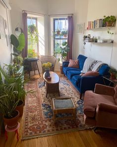 a living room filled with furniture and plants