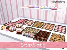 an assortment of doughnuts and pastries on display in front of a pink striped wall