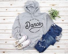 Dance Mom Hooded Sweatshirt, Dance Mom Hoodie, Dance Mom Shirt, Mom Life Shirts, Dance Shirt for Mom, Mom Christmas gift, Dance Mom tee Thanks for checking out our Livin that Dance Mom Life Hooded Sweatshirt! This sweatshirt can be customized with team colors or even a different sport (football, baseball, soccer etc.) Pictured in Black Unisex Hooded Sweatshirt with Pink and Grey Design. Can also be purchased in Women's off the Shoulder Style. ❤ EASY TO ORDER Select Style Shirt: Unisex Hoodie or Dance Hoodies, Dance Mom Shirt, Dance Mom Shirts, Dance Shirt, Retro Svg, Mom Pictures, Womens Hoodies, Dance Mom, Mom Hoodies