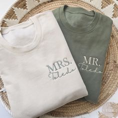 two personalized t - shirts sitting on top of a wicker basket next to each other