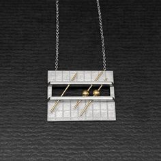 OVERVIEW:  Here's a vintage c1980s studio made sterling necklace.  The pendant is rectangular with a hand-engraved grid pattern.  At the center are two applied bands holding 3 14K gold wires, two of which have 14K beads.  Design has a very cool mathematical/graph-like character!  Pendant is attached to a fine curb link chain with a spring clasp.  This piece is not signed but it comes from a good NYC collection of modernist & contemporary artist jewelry. MARKS:  none, tested and guaranteed sterling & 14K DIMENSIONS: pendant is 1" x 7/8"; wearable length 18" WEIGHT:  7.04g CONDITION:  excellent Modernist Formal Necklace With Large Pendant, Contemporary Formal Jewelry With Rectangular Shape, Contemporary Rectangular Jewelry For Formal Occasions, Contemporary Formal Rectangular Jewelry, Modernist Geometric Jewelry For Formal Occasions, Modern Jewelry With Rectangular Box Chain, Contemporary Sterling Silver Rectangular Jewelry, Modern Silver Rectangular Necklaces, Modern Necklace With Rectangular Pendant And Box Chain