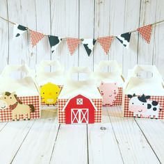 small boxes with farm animals on them sitting in front of a string of bunting