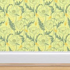 a yellow wallpaper with green and yellow flowers on it, in front of a window