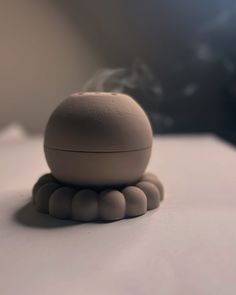 a small white object sitting on top of a table