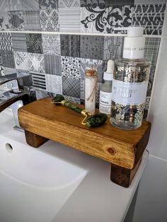 a bathroom with a sink, mirror and soap dispenser on the counter