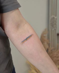 a person with a small tattoo on their arm