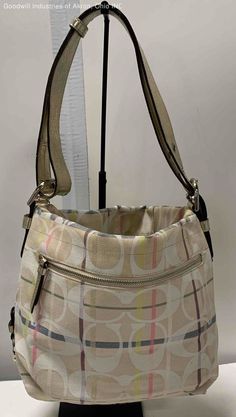 Certified Authentic Beige/multicolor Coach Satchel Handbag Condition: Gently Loved Purse Type & Closure: Satchel Handbag, Zipper Serial Number: A1369-24822E Color & Material: Beige/multicolor, Fabric Approximate Measurements (inches): 4 x 10.75 x 14 x 9 strap drop Thank You for shopping with GIA Blue Boutique! We are a charitable organization with a mission to help individuals prepare for, find, and retain employment. Every purchase directly impacts this mission. Returns: All Sales are AS-IS and Spring Coach Shoulder Bag With Adjustable Strap, Coach Shoulder Bag For Spring Travel, Spring Coach Shoulder Bag For Travel, Multicolor Coach Bags For Spring, Multicolor Coach Bag With Zipper Closure, Coach Multicolor Shoulder Bag With Detachable Strap, Coach Multicolor Shoulder Bag With Detachable Handle, Multicolor Coach Shoulder Bag For Everyday Use, Everyday Multicolor Coach Shoulder Bag