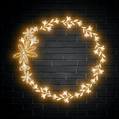 a neon sign that is lit up in the shape of a wreath on a brick wall