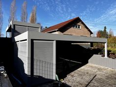 a house with a large garage attached to it's side wall in the backyard