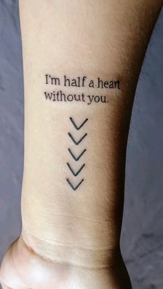 a person with a tattoo on their arm saying i'm half a heart without you