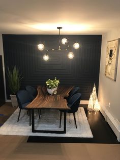 a dining room with black walls and white rug