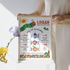 the very hungry caterpillar birthday print is displayed in front of a woman's white dress