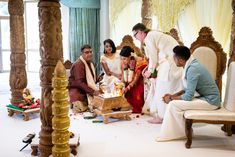 a group of people that are standing around each other in front of a cake on a table