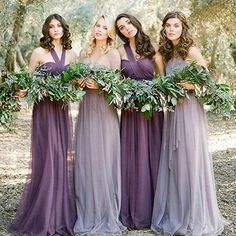 the bridesmaids are wearing purple dresses and holding greenery in their hands together