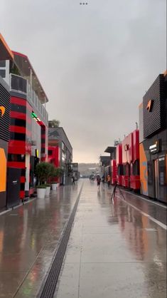 a person walking down a street in the rain