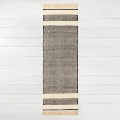 a black and white striped rug hanging on the wall