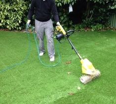 a man is using a lawn mower to clean the grass