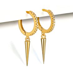 Express yourself with standout Gold Spike dangle earrings. Tiny cubic zirconia crystals inserted in the hoops make them a sparkling beauty. These small Spike charm hoops stand out wearing alone, and they also are perfect when styled with other earrings. Available in Sterling silver and Gold plated. M A T E R I A L S * A N D * D E T A I L S - Sterling Silver - 14K GOLD plated (gold over silver) D I M E N T I O N S 10 mm hoops 13 mm Cone spike drop H O W * T O * O R D E R Choose Silver or Gold opt Hoop Crystal Earrings With Cubic Zirconia For Pierced Ears, Small Hoop Crystal Earrings In Cubic Zirconia, Small Hoop Crystal Earrings With Cubic Zirconia, Pierced Dangle Hoop Earrings In Cubic Zirconia, Earrings Small Hoop, Dainty Initial Necklace, Gold Starburst, Dainty Hoop Earrings, Dangle Earrings Boho