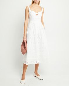 Price Comparison Few Moda $69 STAUD $325 Reformation $278 Product Details The Tomi Dress features a delicate white eyelet lace and a unique neckline with a keyhole detail, creating a charming and elegant look. Finished with a full and flouncy skirt for optimized frolicking. - Back zipper- Lining- Content: 100% Cotton Style# T23WDR09301 Fit Notes - Model wearing a size 2 - Model measurements: 5'10'' Height / 32'' Bust / 24'' Waist / 34'' Hips- Garment measurements: Size Length Bust Waist 0 102.55 White Midi Dress With Broderie Anglaise For Wedding, Chic Fitted Eyelet Midi Dress, White Dress With Cutwork Hem For Garden Party, White Eyelet Dress For Brunch, Chic Eyelet Midi Dress, Summer Wedding Dress With Eyelet Details, White Broderie Anglaise Midi Dress For Brunch, Elegant Fitted Broderie Anglaise Midi Dress, Sleeveless Broderie Anglaise Dress For Day Out