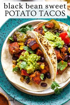 two black bean sweet potato tacos on a blue plate