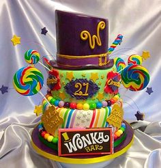 a multi - tiered birthday cake with candy and candies