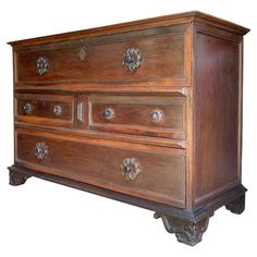 an old wooden dresser with metal handles and knobs on the front, against a white background