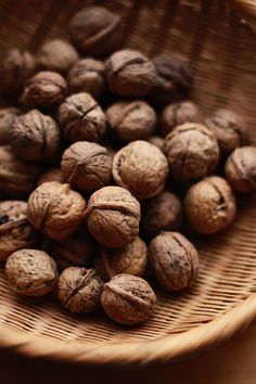 walnuts in a wicker basket on a table