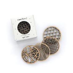 the coasters are made out of wood and have geometric designs on them, as well as a box